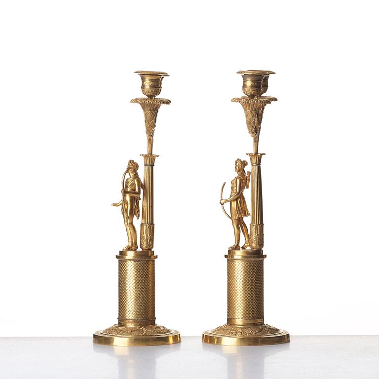 A pair of French Empire two-light gilt bronze candelabra, early 19th century.