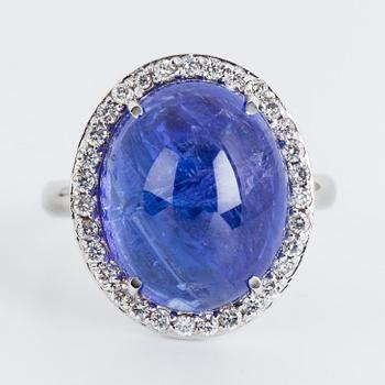 Cabochon-cut tanzanite and brilliant-cut diamond cocktail ring.