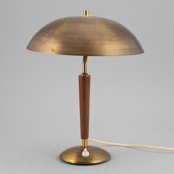 A brass and teak table lamp, 1960's.