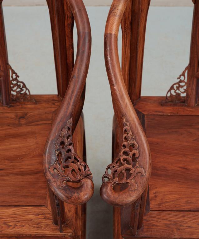 A pair of hardwood horseshoeback armchairs, late Qing dynasty, circa 1900.