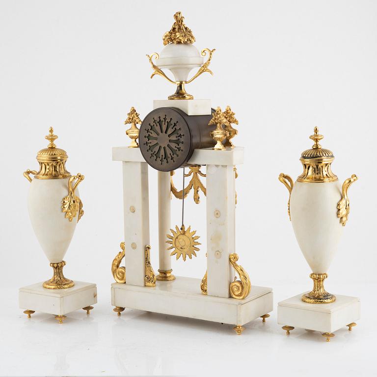 A set with a mantle clock and two urns, France, circa 1900.