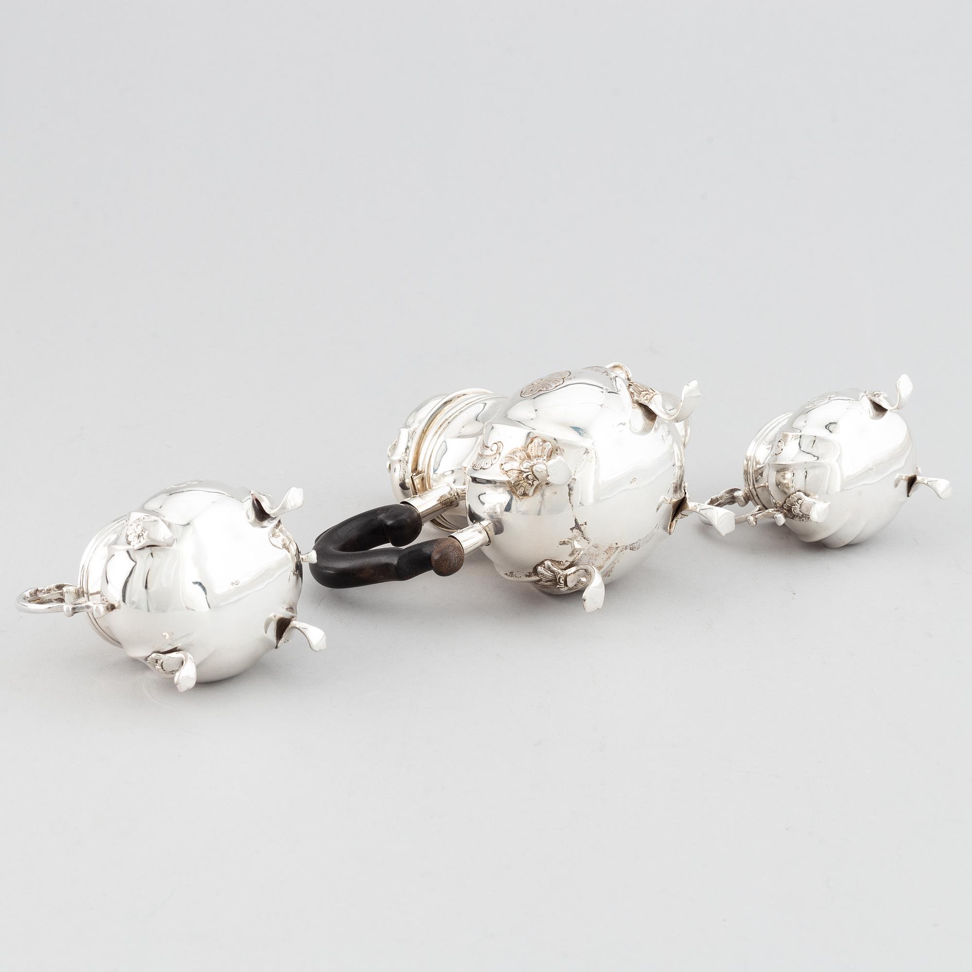 An early 20th century Rococo-style parcel gilt and silver three part coffee service.