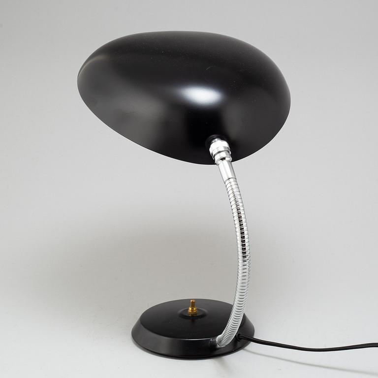 A 'Cobra' table lamp by Greta Magnusson Grossman, Gubi.