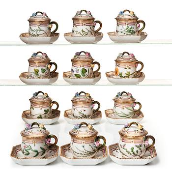 A set of 12 Royal Copenhagen 'Flora Danica' custard cups with covers and stands, Denmark, 20th Century.