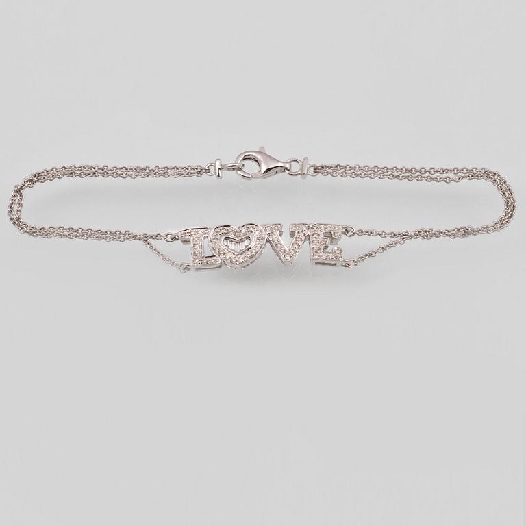 ARMBAND, 18K vitguld med briljant och baguettslipade diamanter ca 0.19 ct. Vikt 2,9 gram.