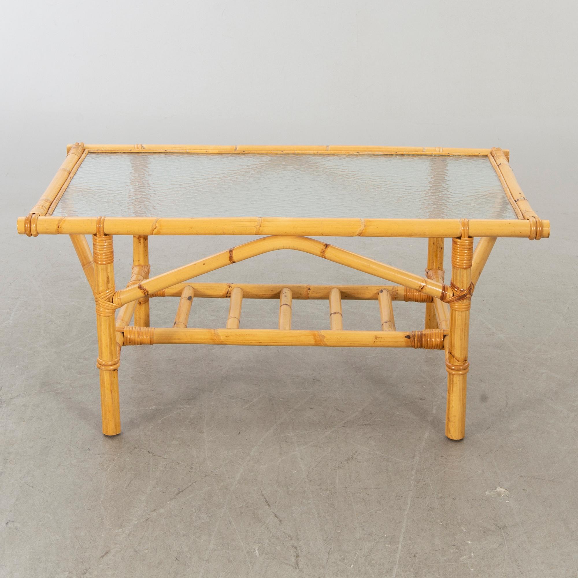 A set of ratten furniture, late 20th century; sofa, armchairs and a lounge table.