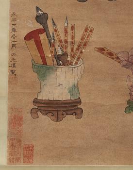 A hanging scroll with flowers and items from the scholars desk, late Qing dynasty (1644-1912).