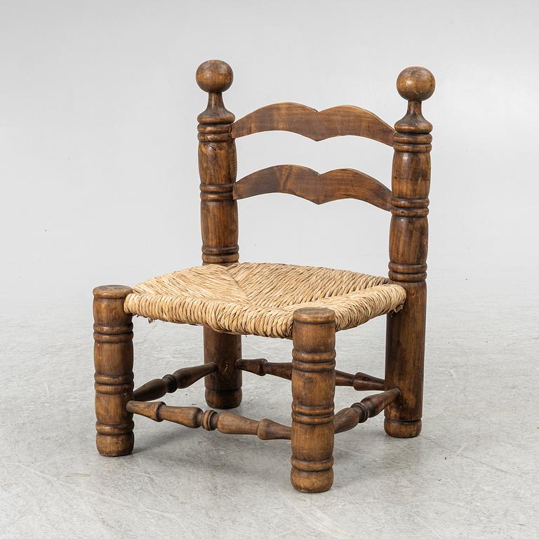 Charles Dudouyt, attributed to, a fireside low chair, mid 20th century.