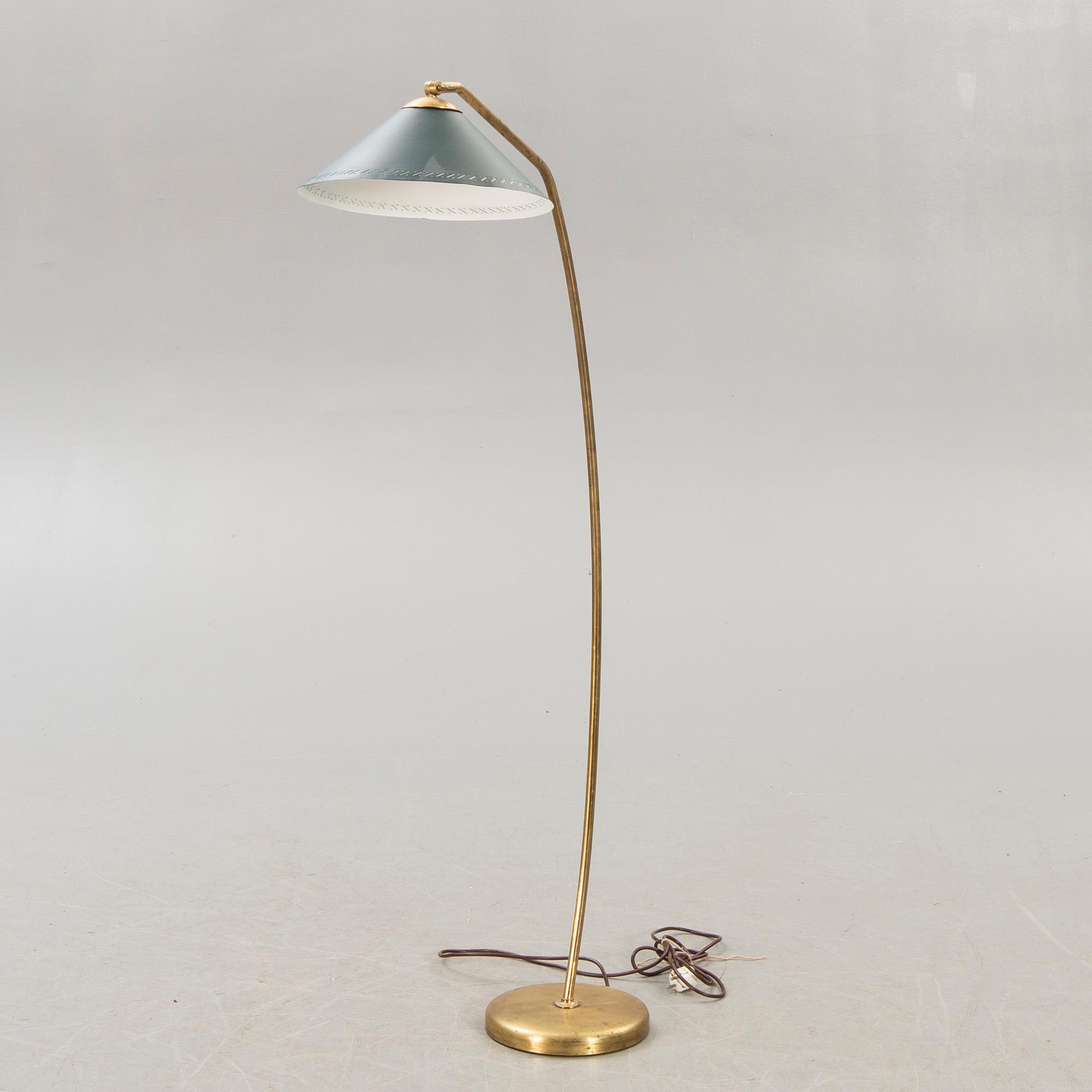 A 1950s brass floor lamp.