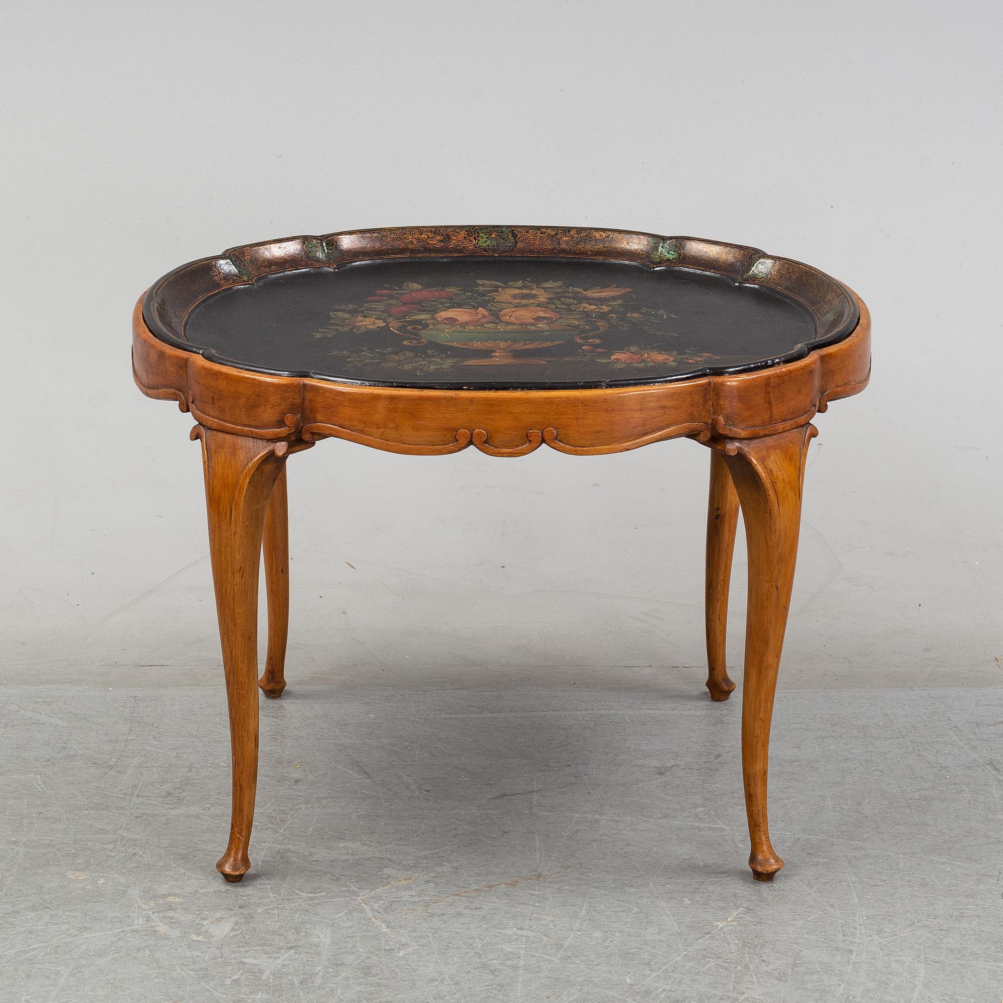 A rococo style side table with a loose tray.