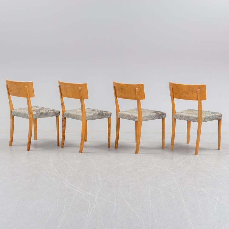 A 1940's dining table an four chairs.