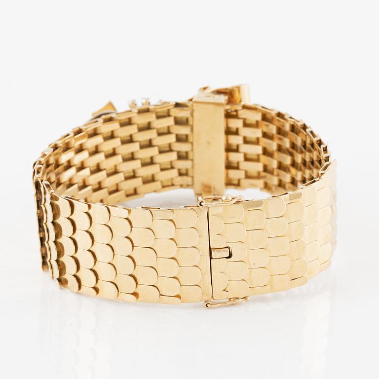 Bracelet in 18K gold with white stones.