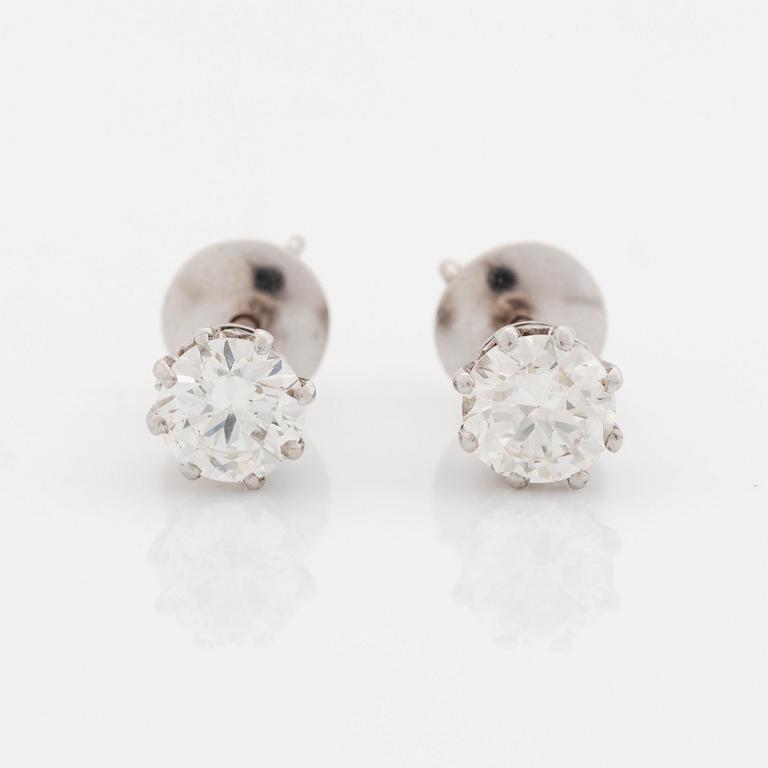 A pair of 18K white gold earrings set with round brilliant-cut diamonds.