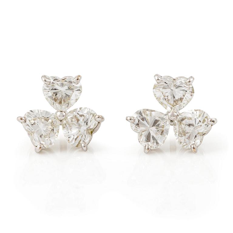 A pair of Cartier earrings in 18K white gold with six heart-shaped brilliant-cut diamonds.