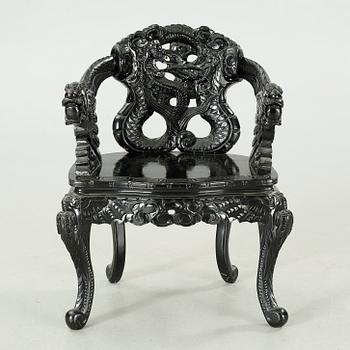 A Japanese 20th century arm chair.