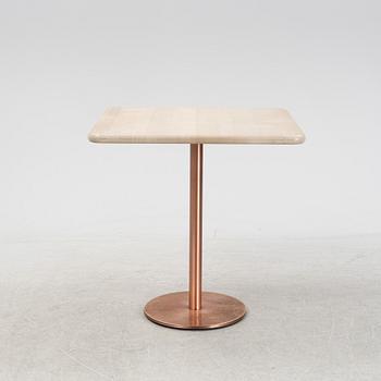 A steel and oak table by Jonas Lindvall 2011.