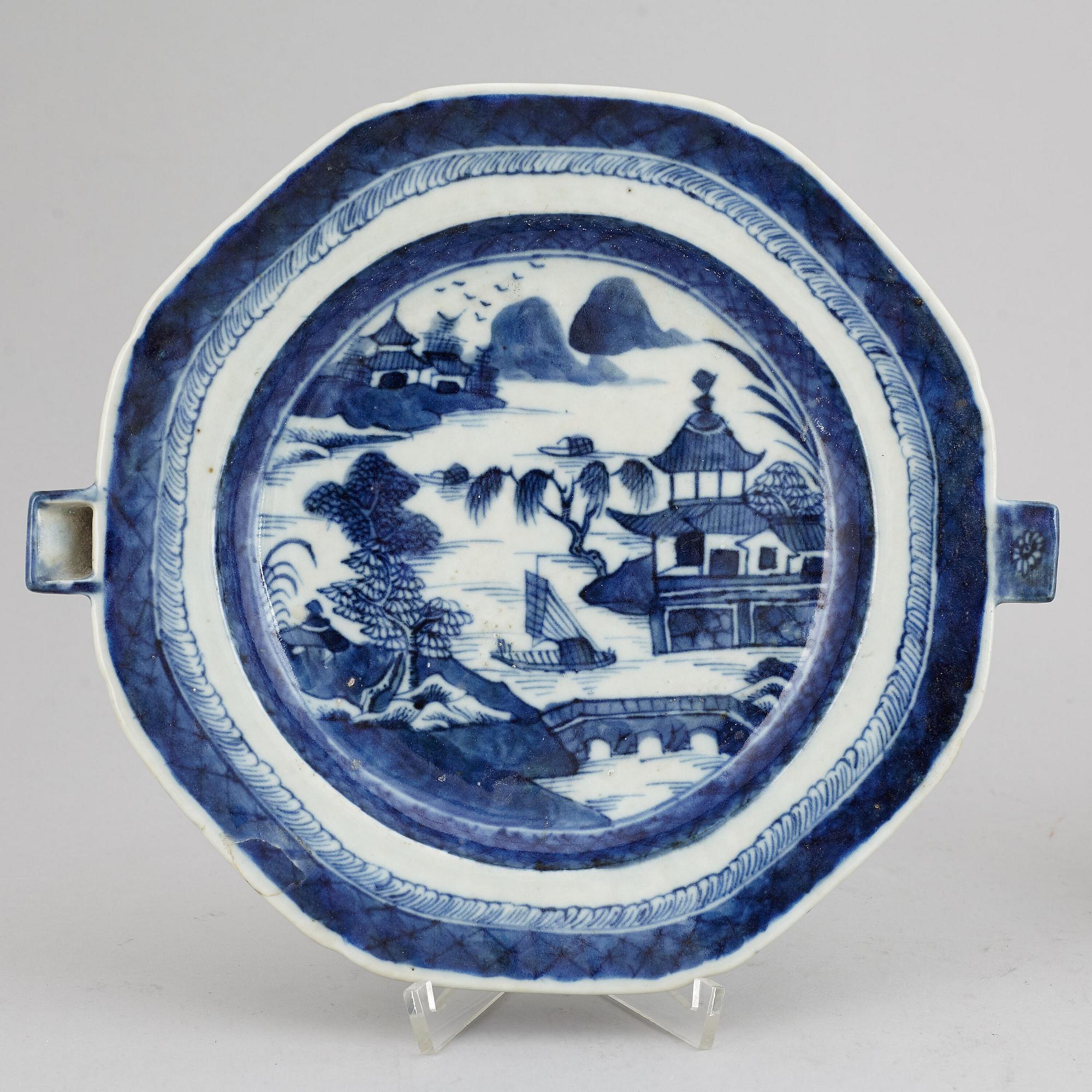 A set of three blue and white plates and a hot water dish, Qing dynasty, 18th/19th Century.