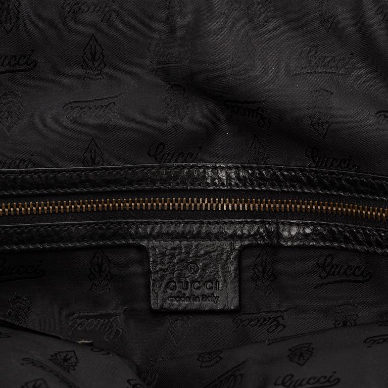 Gucci, a black leather handbag.