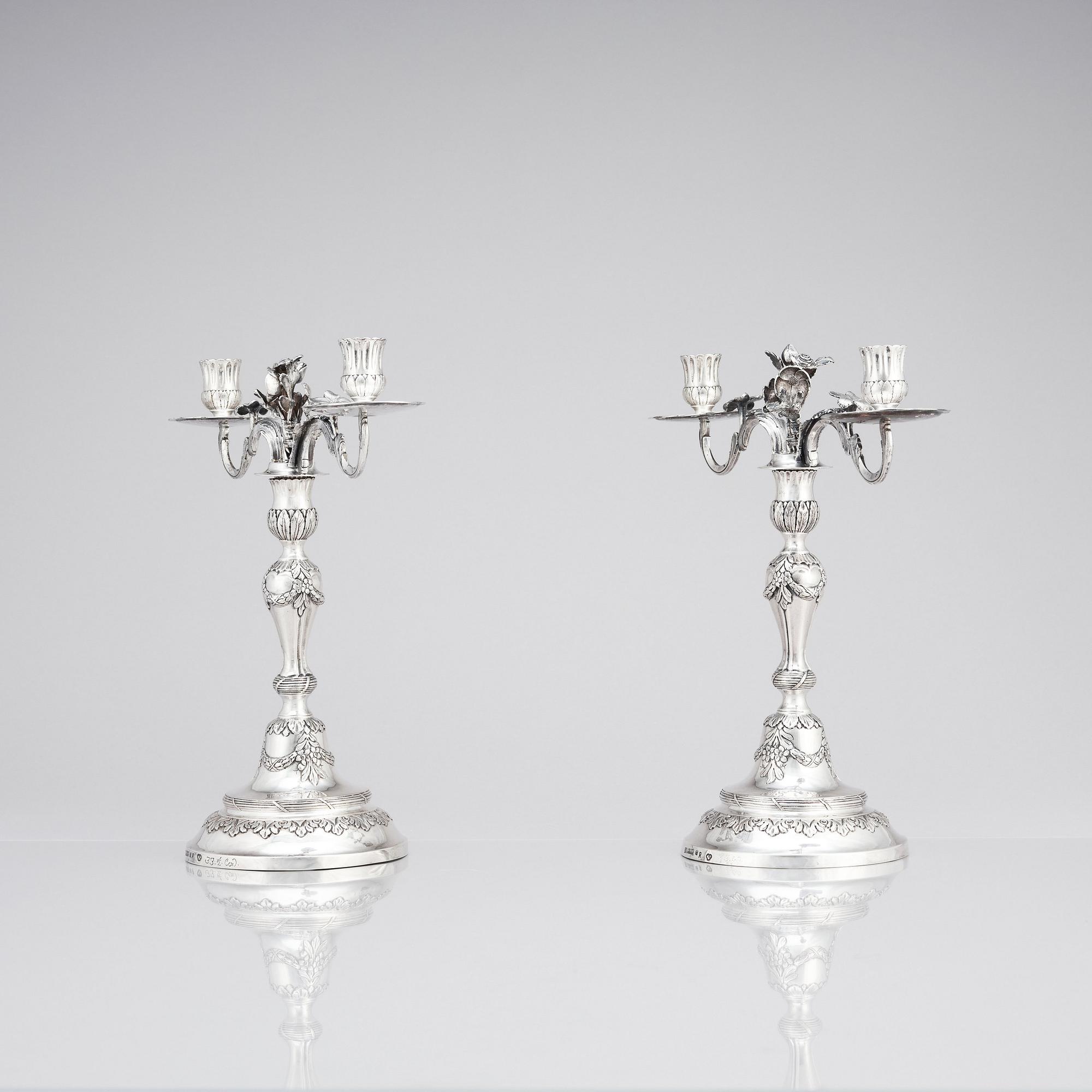 A pair of Swedish 18 century silver candelabras, mark of Lars Åkerblom Gävle 1775, arms by Christian Kullberg.