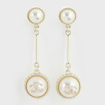 A pair of Chanel earrings.