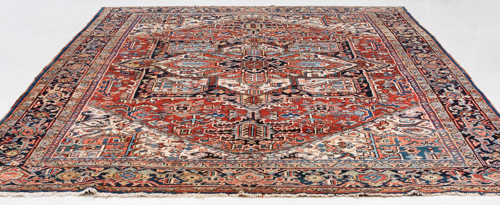 A semi-antique Heris carpet, c. 364 x 299 cm.