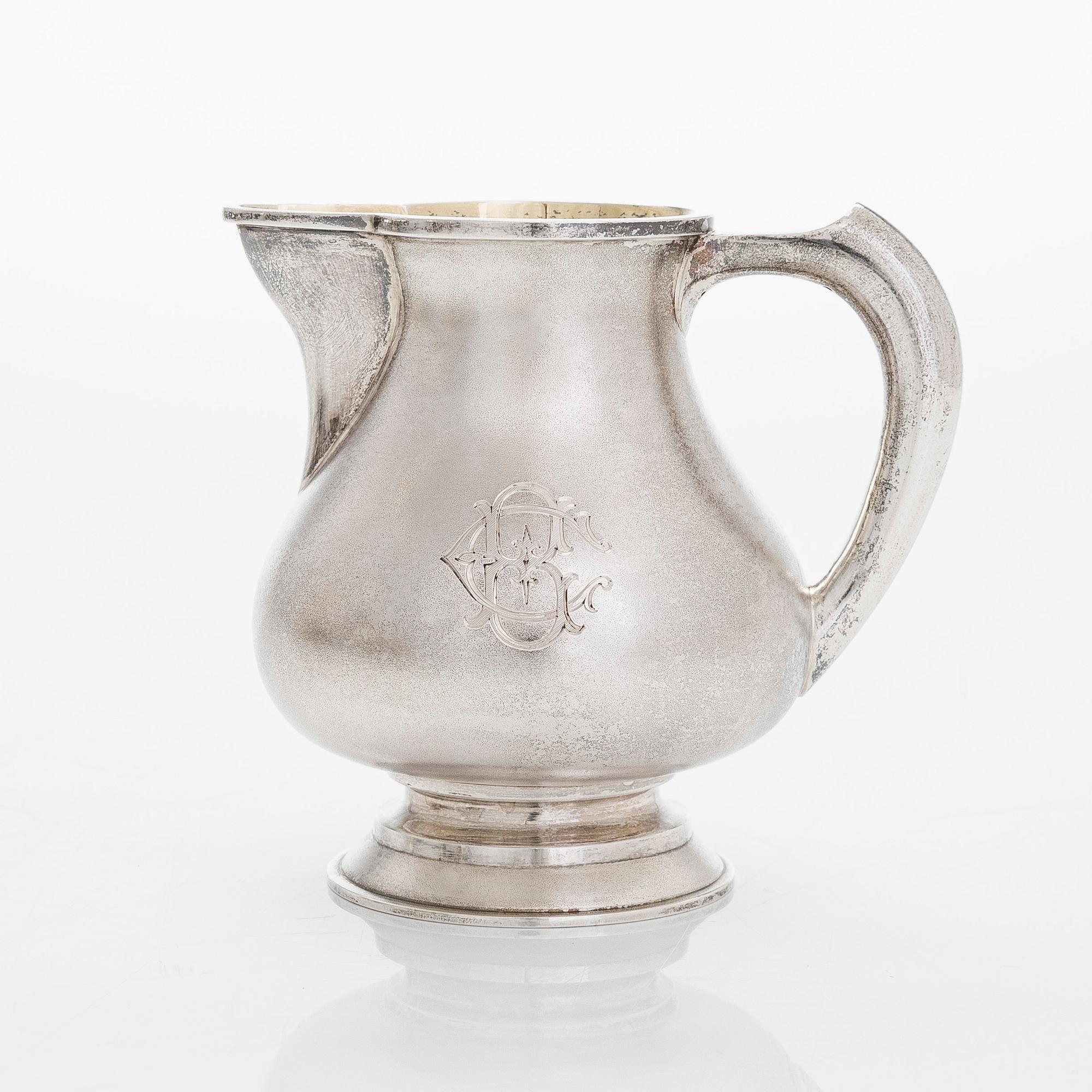 A four-piece silver coffee set, St. Petersburg 1887, original fitted box from Khlebnikov. Sugar tong, Moscow around 190.