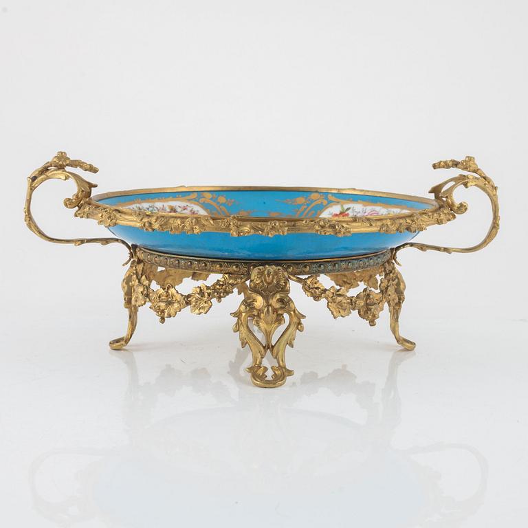 A French porcelain and brass centrepiece, second half of the 19th Century.