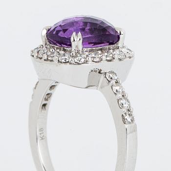 Brilliant-cut diamond and checker-cut amethyst ring.