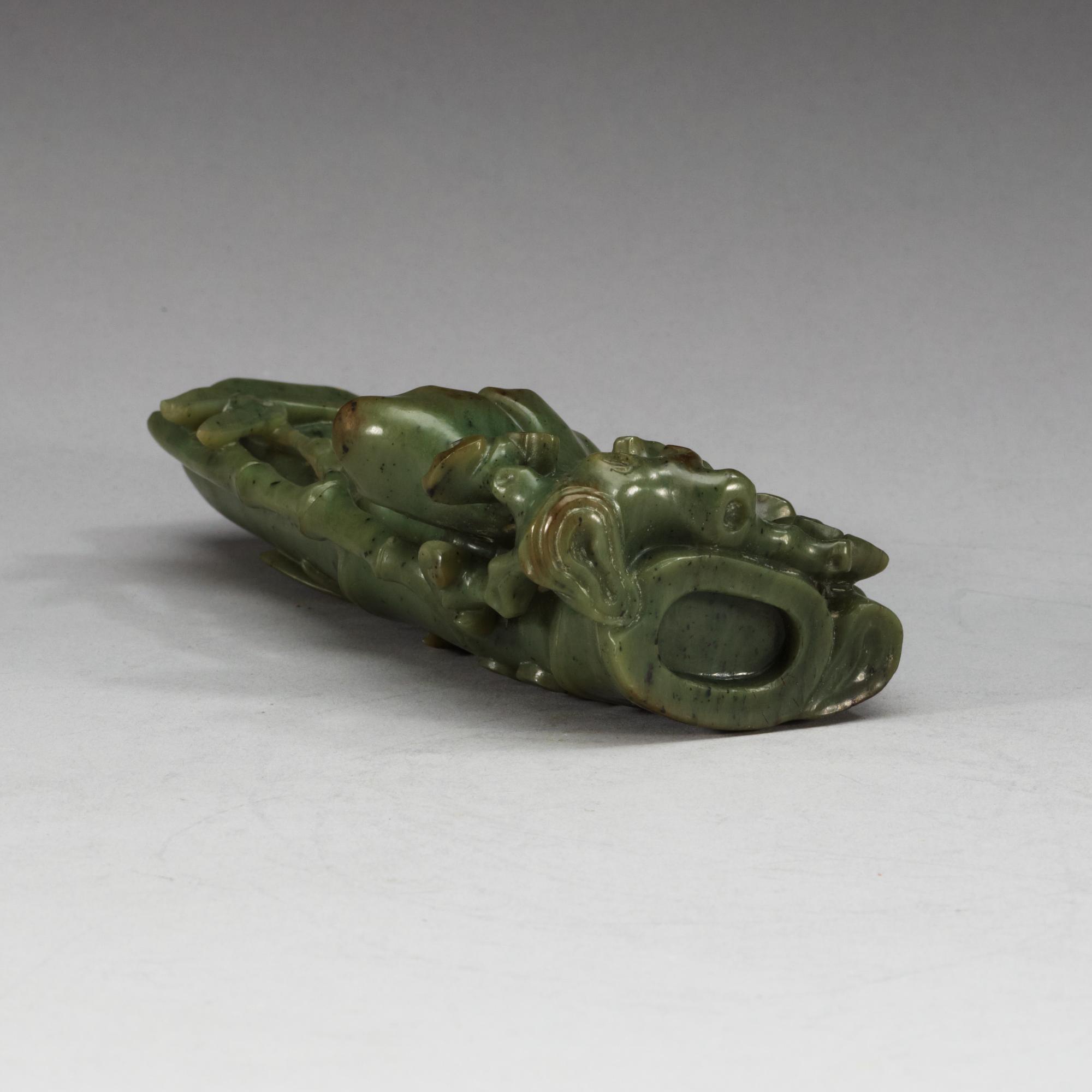 A  carved green stone sculpture, late Qing dynasty.