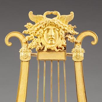 A late Gustavian early 19th century gilt bronze mantel clock.