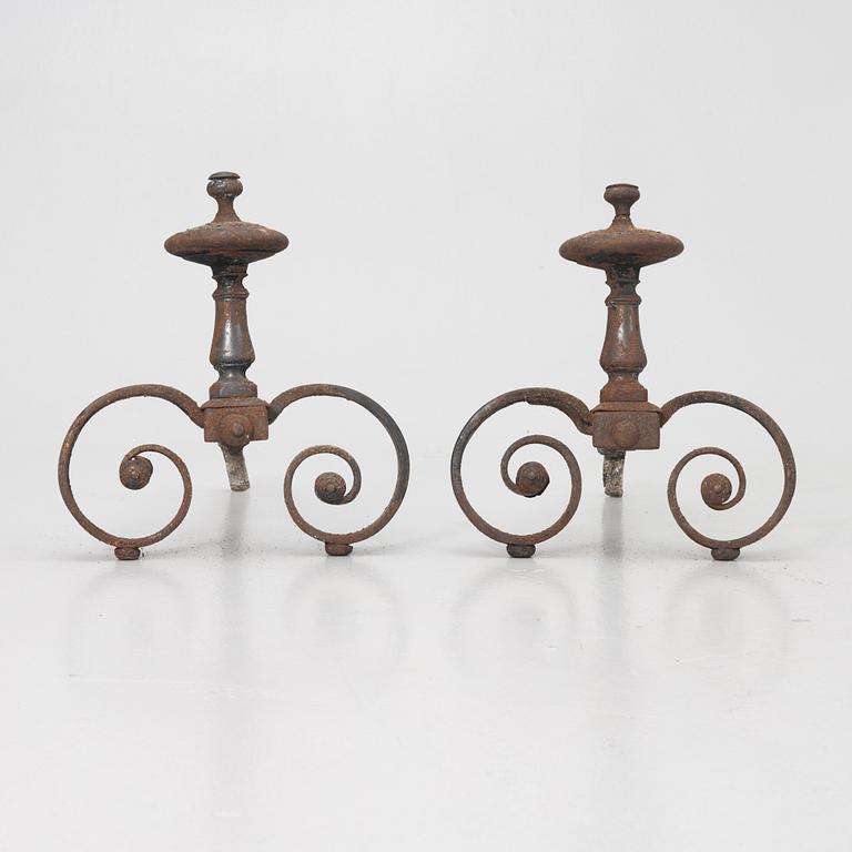 A pair of wrought iron fire dogs.