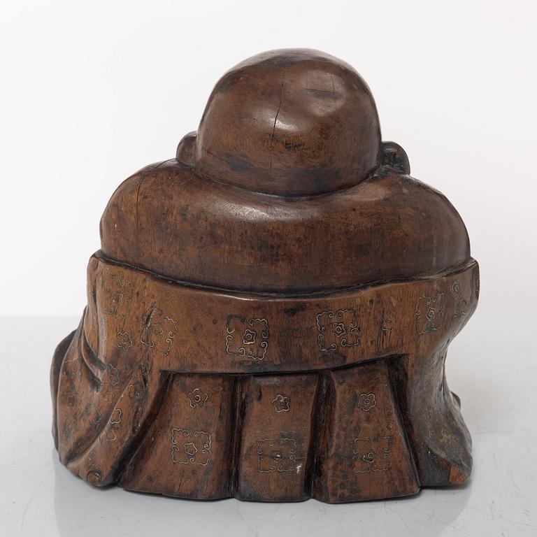 A Chinese wooden figure of Budai with silver inlays, Qing dynasty (1644-1912).