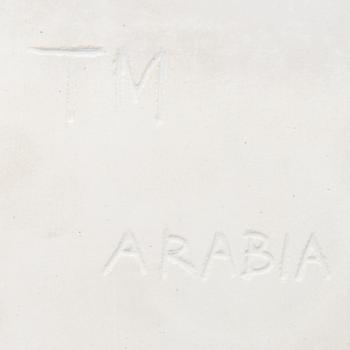 A ceramic art plate with leaf motif signed TM Arabia.