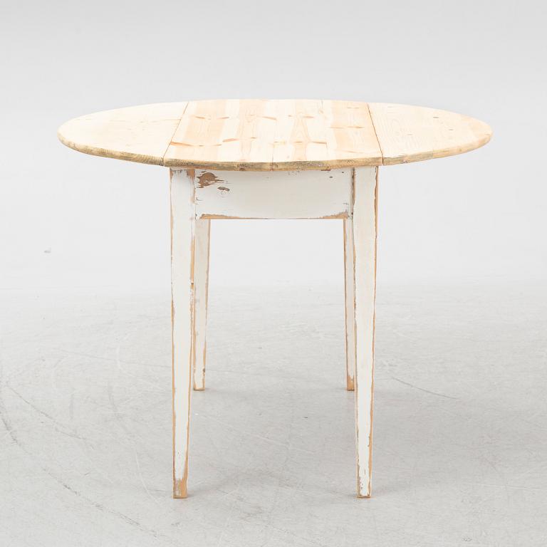 A drop-leaf table, circa 1900.