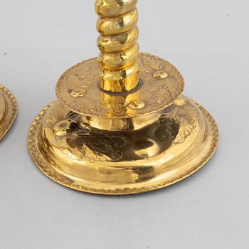 A pair of brass baroque style candlesticks, end of the 19th century.