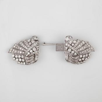 A brilliant-cut diamond brooch/clips in the shape of two swans. Circa 1940's. French hallmarks.