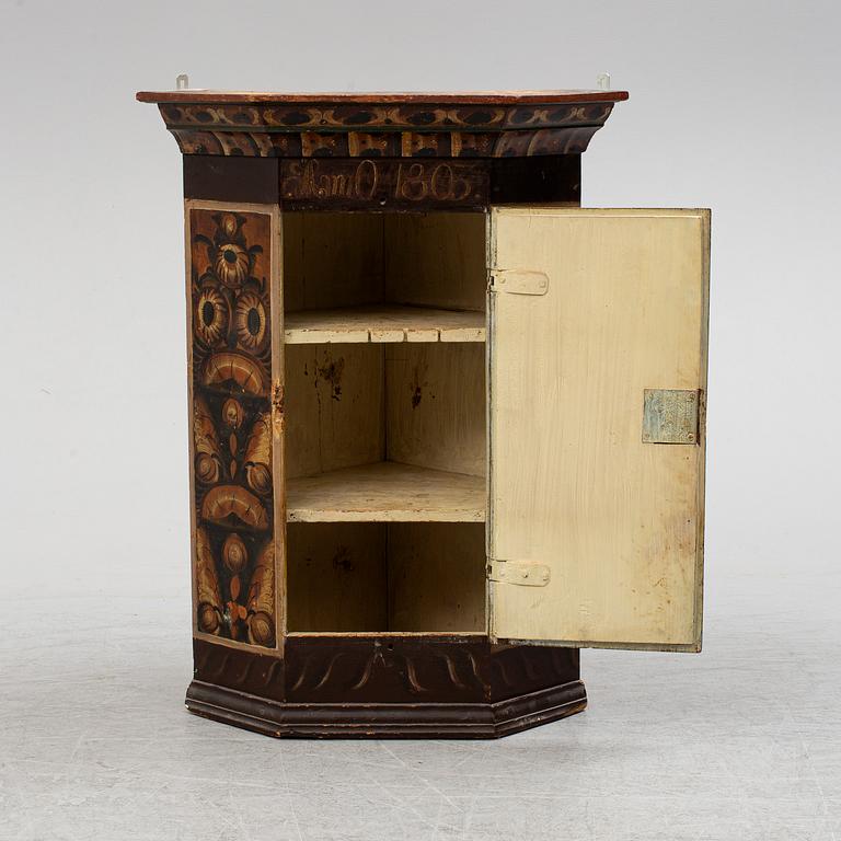 A Swedish painted wall cupboard, dated 1803.