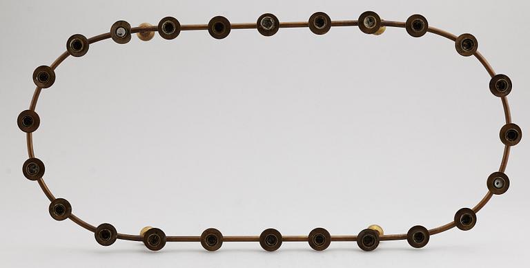 A mid 20th Century brass candle ring.