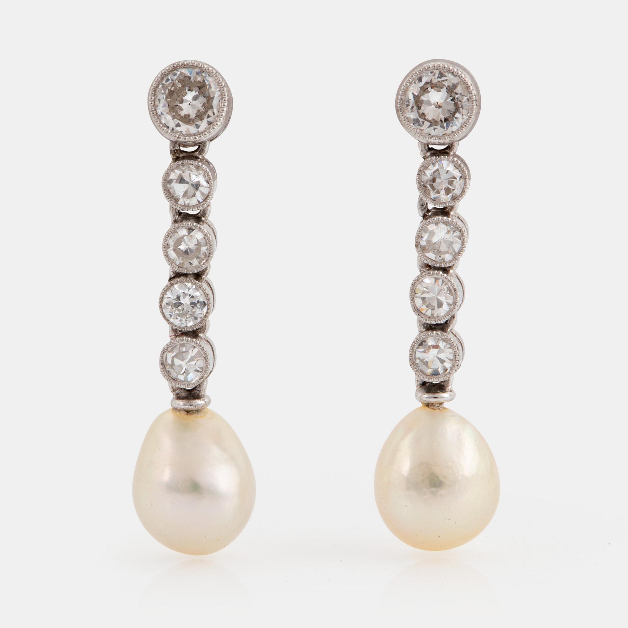A pair of platinum and 18K white gold earrings set with pearls and old- and eight-cut diamonds.