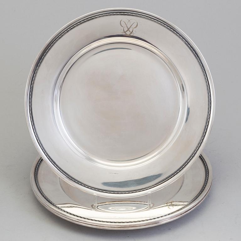 Four monogrammed Swedish silver charger plates, Makers's mark GAB, Stockholm, 1949.