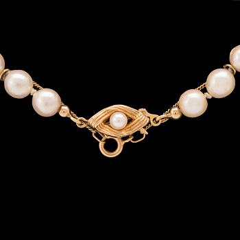 A set of necklace, ring, and earrings with cultured pearls and 18K gold.