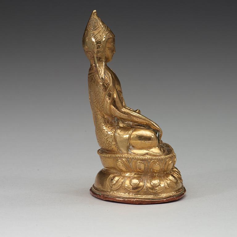 A Tibetan copper alloy figure of a Lama, circa 1900.