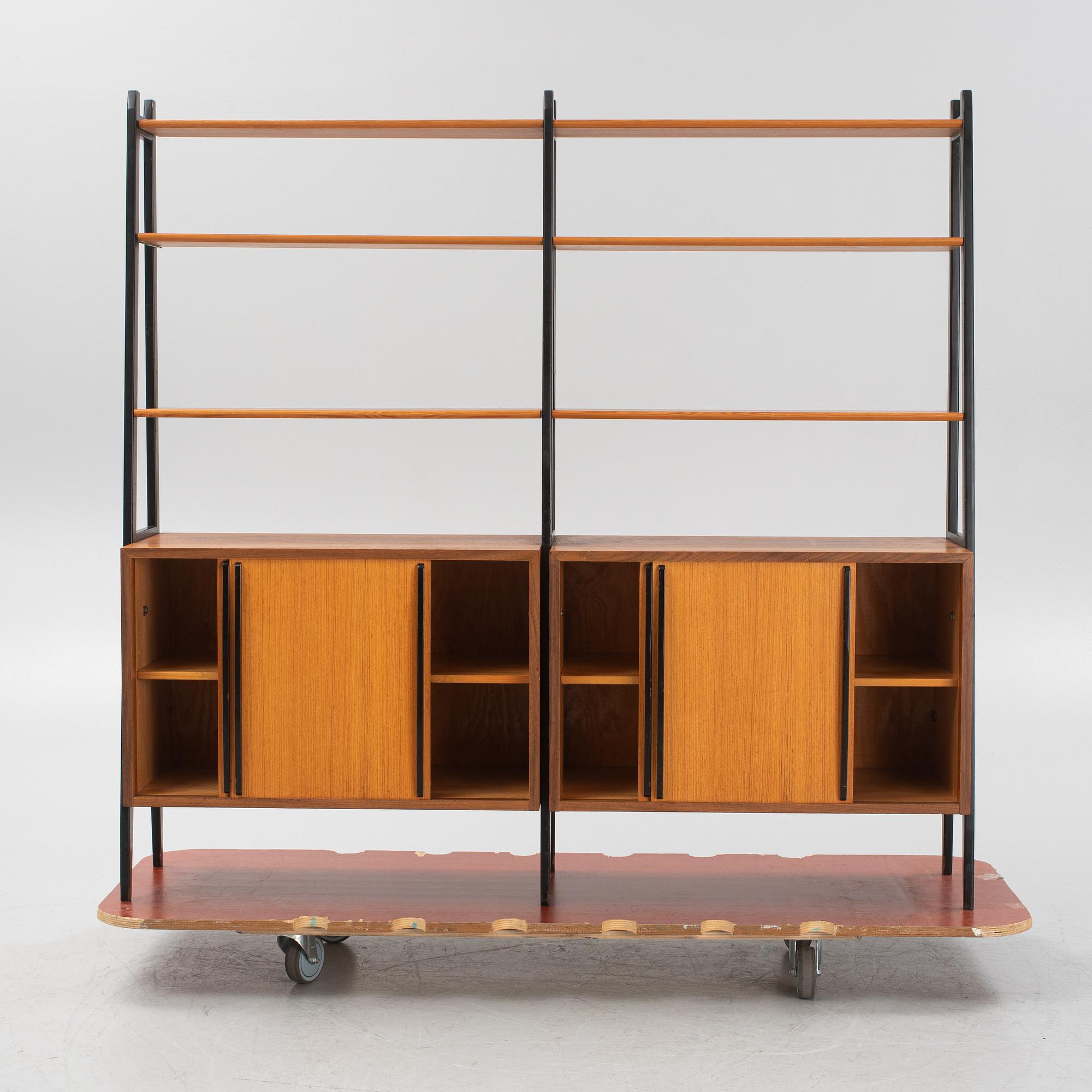 Teak veneered book cases with cabinets.