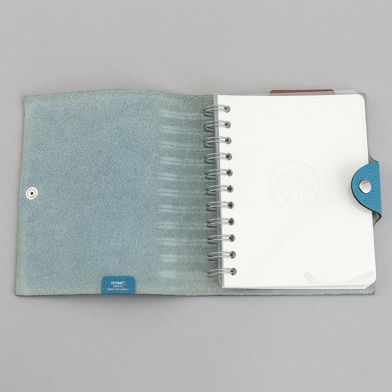 Hermès, a blue leather notebook with two scripple pads.