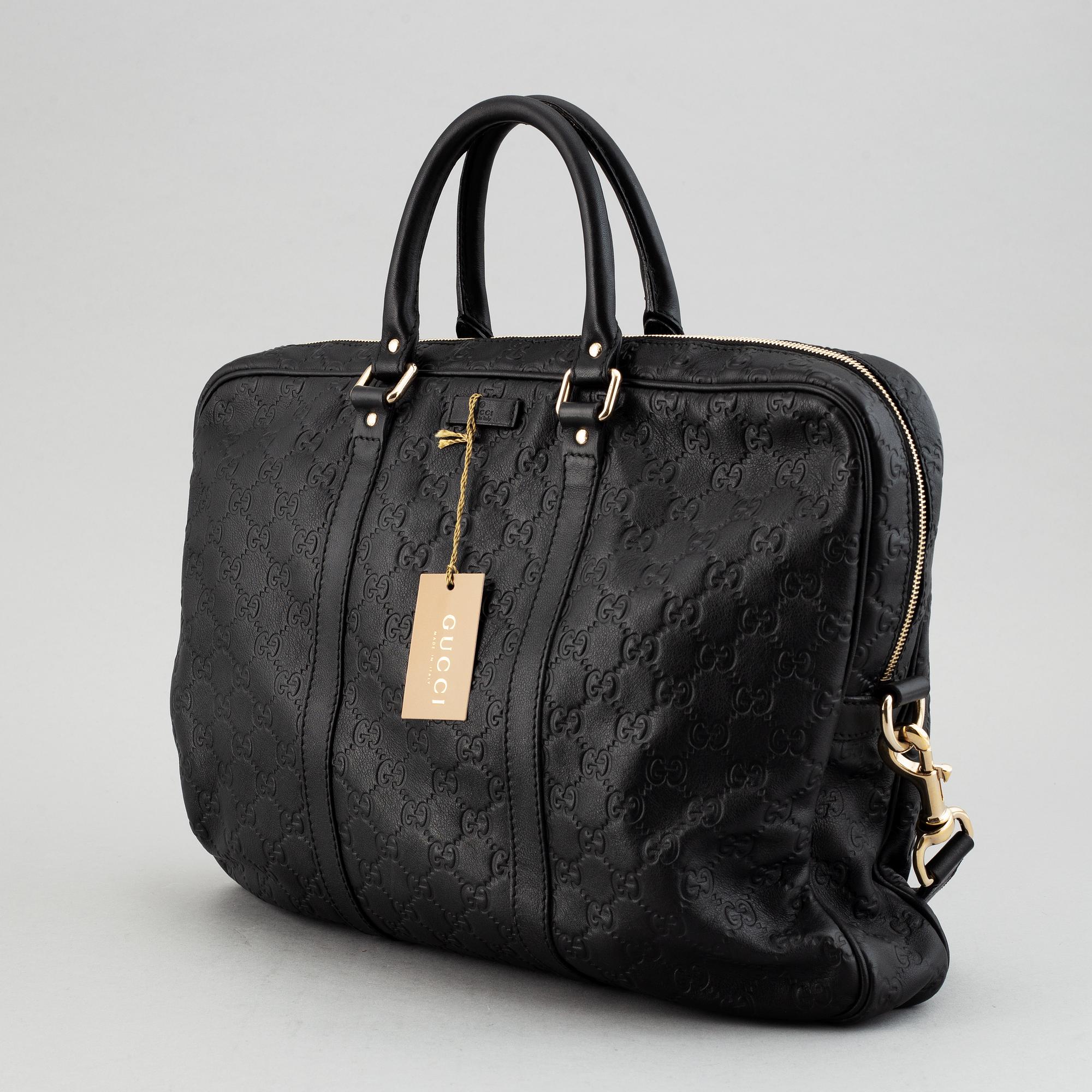 Gucci, a monogram leather bag/laptop-bag.