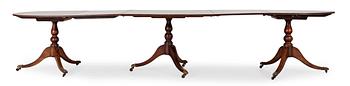 1505. An English Regency and later mahogany dining table.