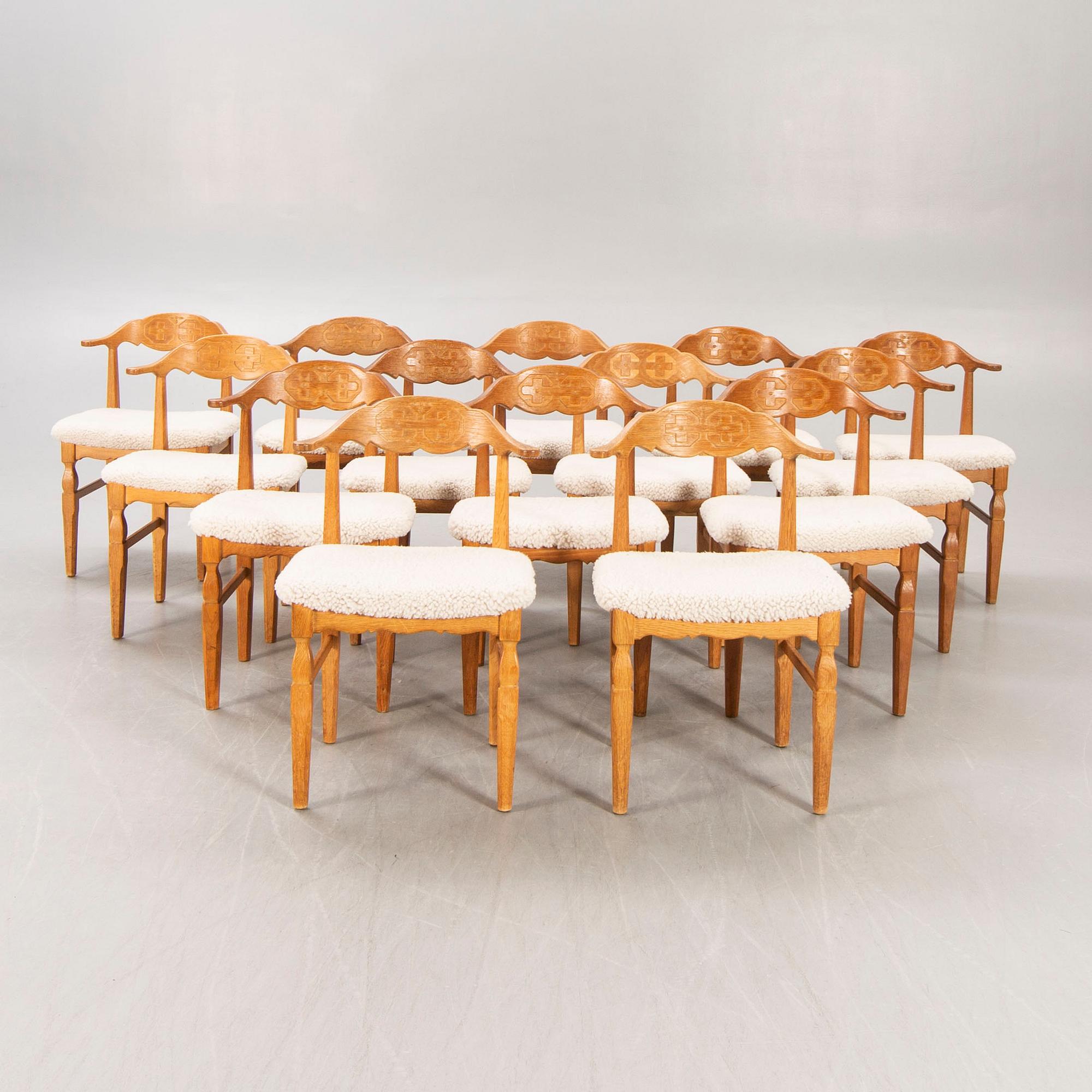 A set of 14 Henning Kjaerulf 1950s oak chairs.