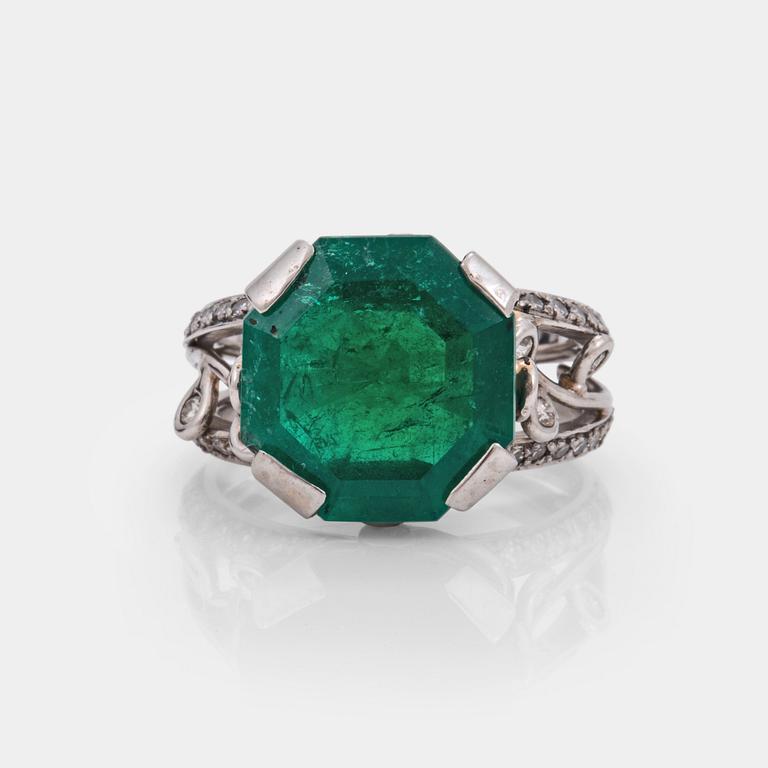 An octagonal cut 6.50 ct emerald and brilliant cut diamond ring. Mandelstam 'Ice Age'.