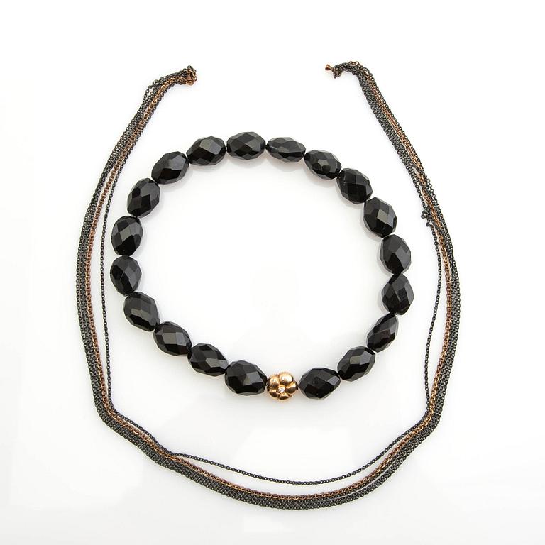 Ole Lynggaard, clasp, 18K gold with a round brilliant-cut diamond, and two necklaces.