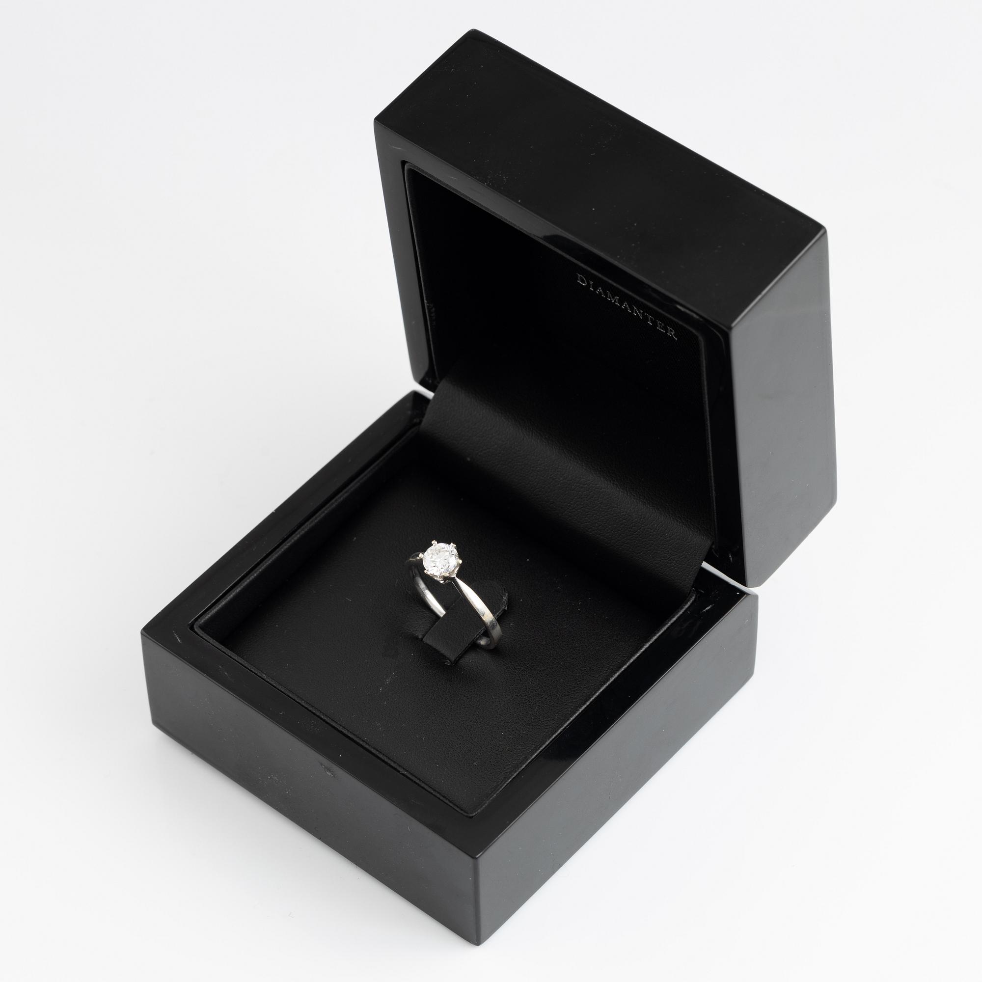 A 14K gold ring set with a round brilliant-cut diamond.